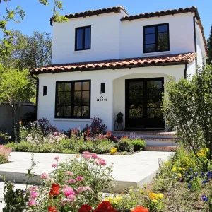 Charming White Cottage with Blooming Garden