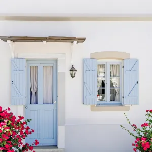 Azure Shutters Amid Blossoming Bougainvillea