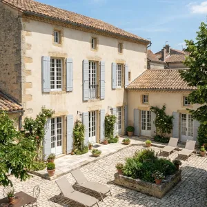 Sunwashed Courtyard With Shuttered Stone Manor