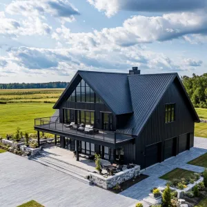 Sleek Black Barndominium in a Sunny Field