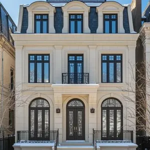 Elegant Snow-Capped Manor on Winter Street