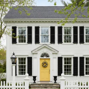 Sunny Door Colonial With Black Shutters